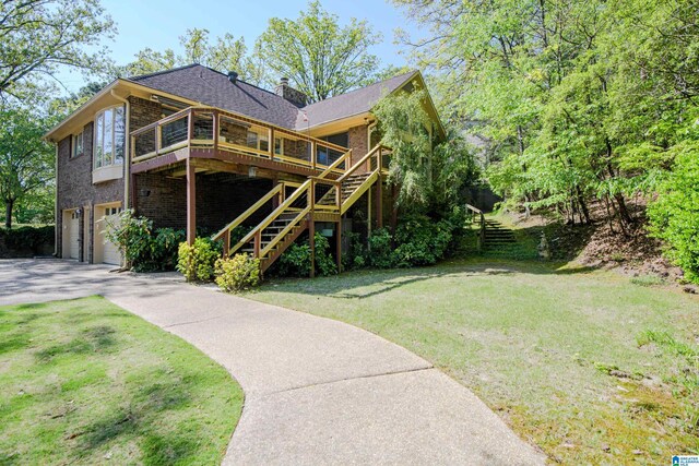 5000 Cameron Rd, Birmingham, AL 35242 - rear view of property with stairway, an attached garage, driveway, a lawn, and a deck
