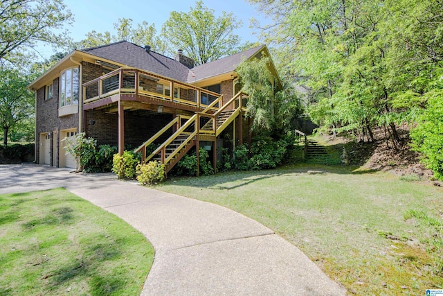 5000 Cameron Rd, Birmingham, AL 35242 - rear view of property with stairway, an attached garage, driveway, a lawn, and a deck