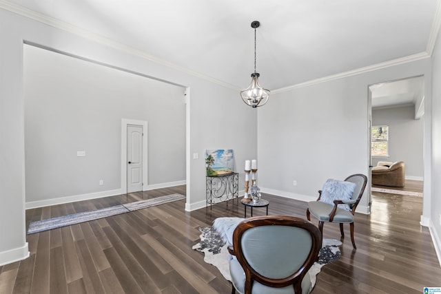 living area with crown molding, wood finished floors, and baseboards