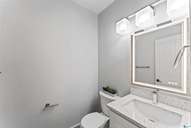 half bath featuring toilet and vanity