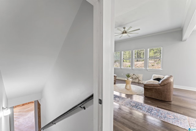 interior space with baseboards, hardwood / wood-style floors, crown molding, and ceiling fan
