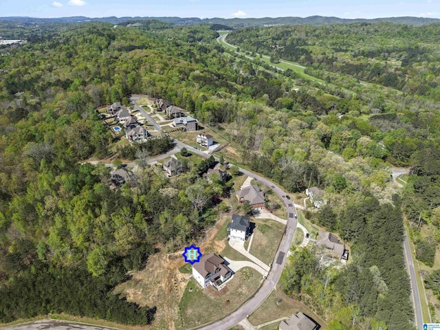 birds eye view of property with a forest view