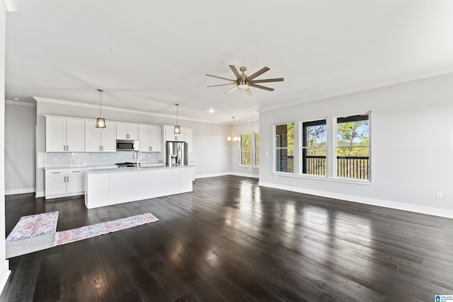 unfurnished living room featuring dark wood-type flooring, ornamental molding, ceiling fan, and baseboards