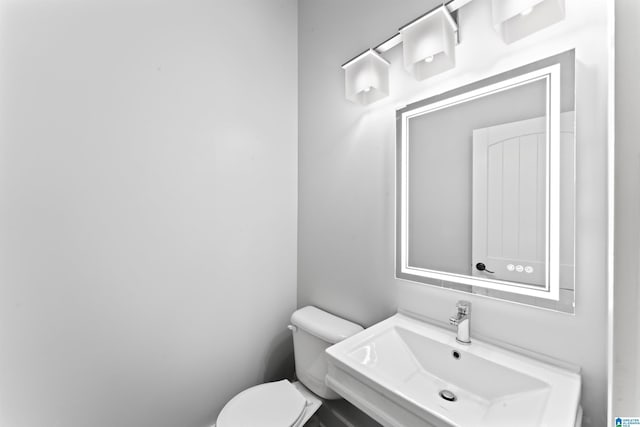 half bath with toilet and a sink
