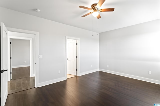 unfurnished bedroom with dark wood-style flooring, baseboards, and ceiling fan