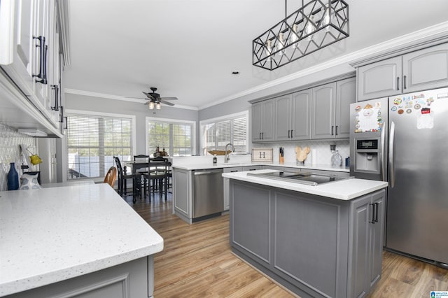 kitchen featuring ceiling fan, appliances with stainless steel finishes, and gray cabinetry