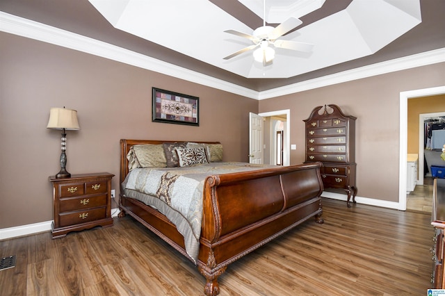 bedroom featuring crown molding, baseboards, ceiling fan, and wood finished floors