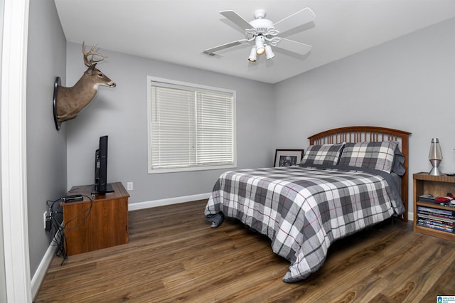 bedroom with wood finished floors, baseboards, a ceiling fan, and visible vents