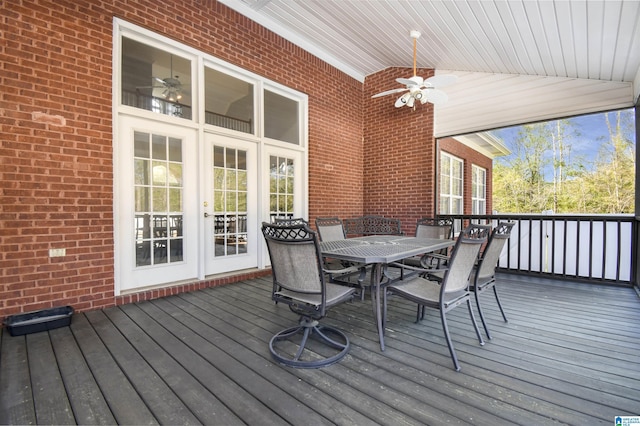 wooden deck featuring outdoor dining space and a ceiling fan