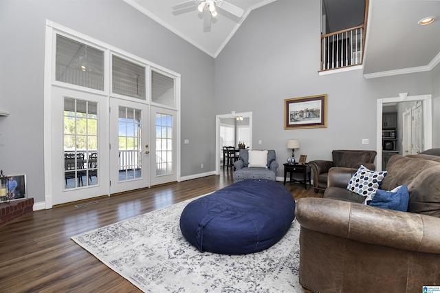 living area with high vaulted ceiling, dark wood finished floors, a ceiling fan, french doors, and baseboards