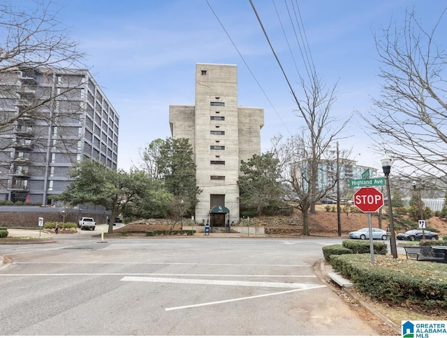 view of building exterior with uncovered parking