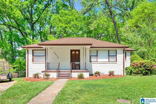6616 4th Ave S, Birmingham, AL 35212 - view of front of house featuring a porch, a front yard, fence, and brick siding