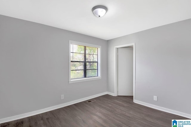 6616 4th Ave S, Birmingham, AL 35212 - empty room with visible vents, baseboards, and dark wood finished floors