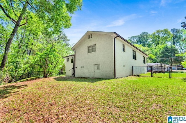 6616 4th Ave S, Birmingham, AL 35212 - view of property exterior with a yard, fence, a gate, and stucco siding