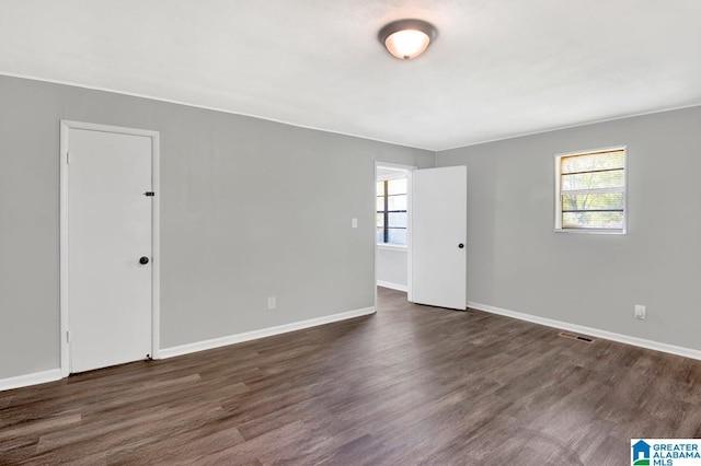 6616 4th Ave S, Birmingham, AL 35212 - empty room with dark wood-type flooring, baseboards, visible vents, and a wealth of natural light