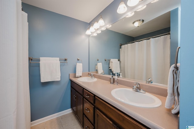 12723 Oak Forest Dr, Lake View, AL 35111 - bathroom with double vanity, a sink, tile patterned flooring, and baseboards
