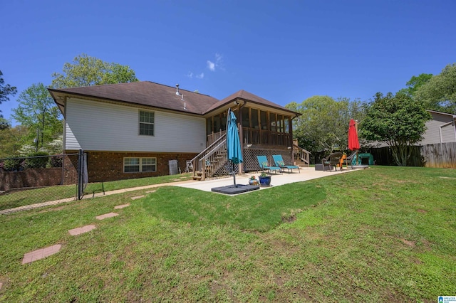 12723 Oak Forest Dr, Lake View, AL 35111 - back of house with a sunroom, a patio area, a lawn, a fenced backyard, and brick siding