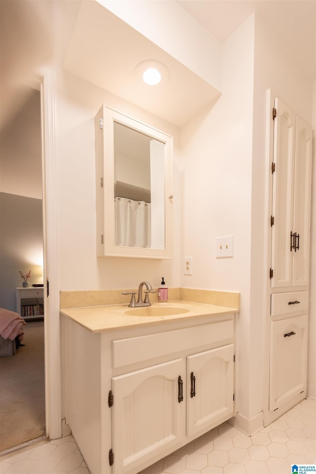 bathroom with tile patterned flooring and vanity