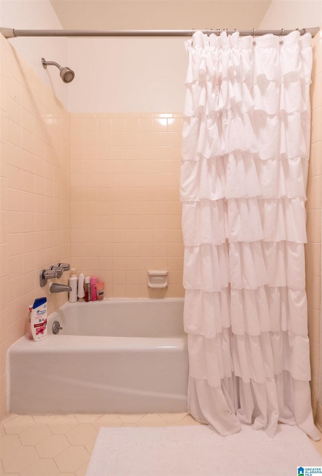 bathroom featuring shower / bath combination with curtain and tile patterned floors