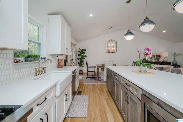 3260 Wisteria Dr, Vestavia Hills, AL 35216 - kitchen with vaulted ceiling, light countertops, backsplash, light wood finished floors, and a sink