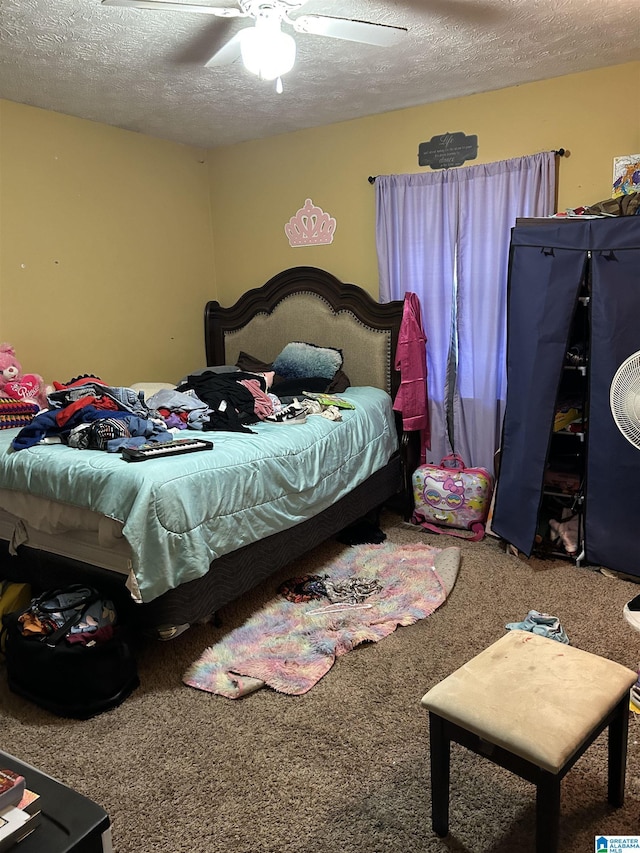 385 Cloverdale Dr, Sylacauga, AL 35150 - bedroom featuring carpet floors, ceiling fan, and a textured ceiling