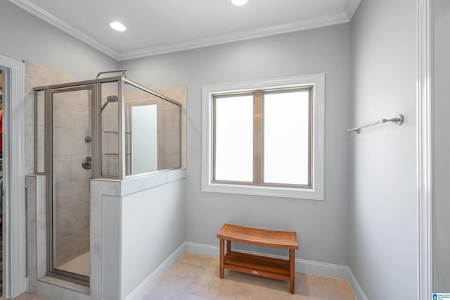 bathroom featuring a shower stall, tile patterned floors, baseboards, and crown molding