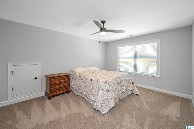 bedroom featuring light carpet, baseboards, a ceiling fan, and visible vents