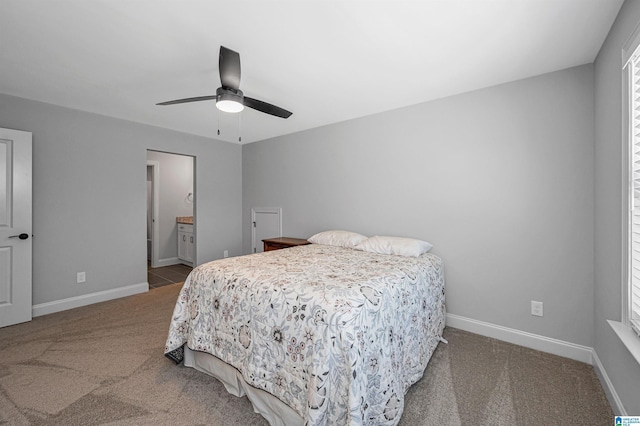 bedroom featuring ensuite bathroom, baseboards, a ceiling fan, and carpet flooring