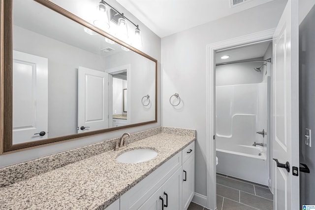 bathroom with tile patterned floors,  shower combination, vanity, and toilet
