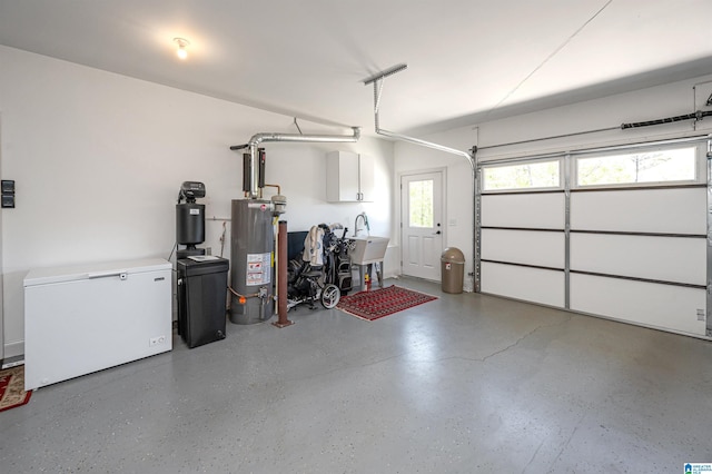 garage with fridge, water heater, and a sink