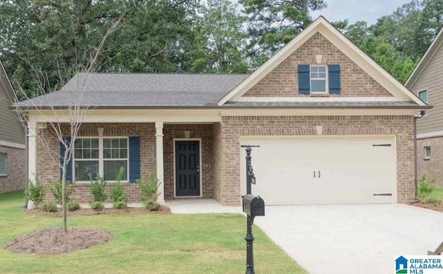 craftsman-style home with driveway, brick siding, a front yard, and a garage