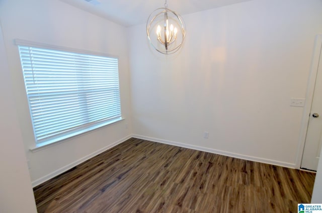 unfurnished dining area with a chandelier, wood finished floors, and baseboards