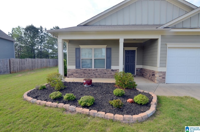 craftsman-style house with a porch, stone siding, fence, board and batten siding, and a front yard