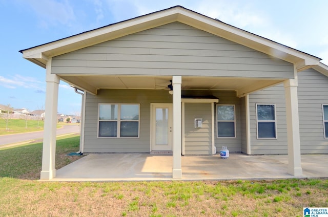back of property featuring a yard, a patio area, and ceiling fan