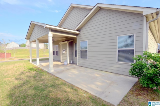 back of house featuring a yard and a patio area