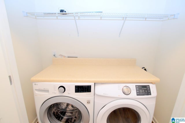 clothes washing area with washing machine and clothes dryer