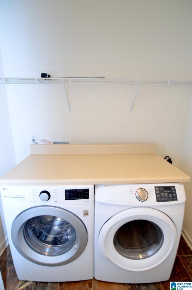 laundry area with washing machine and clothes dryer, laundry area, and baseboards