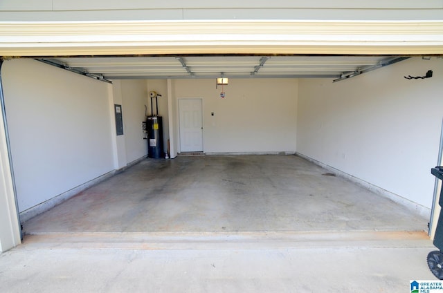 garage featuring electric panel and electric water heater