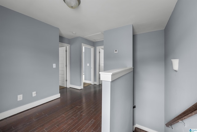 unfurnished room featuring dark wood-type flooring and baseboards