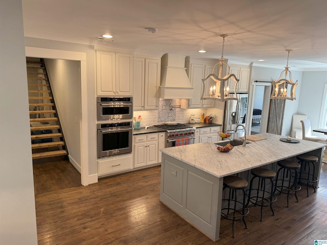 672 Kent Dairy Rd, Alabaster, AL 35007 - kitchen with a chandelier, premium range hood, crown molding, stainless steel appliances, and a sink