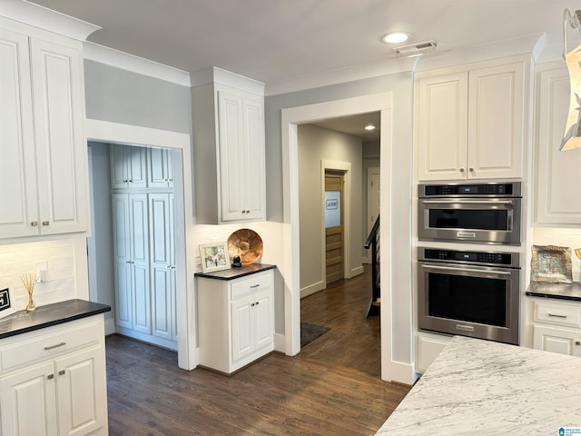 672 Kent Dairy Rd, Alabaster, AL 35007 - kitchen featuring tasteful backsplash, white cabinets, dark wood-type flooring, visible vents, and double oven