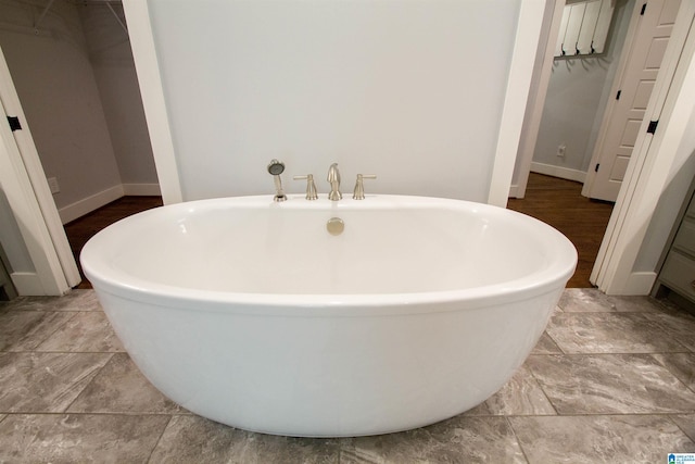 672 Kent Dairy Rd, Alabaster, AL 35007 - bathroom featuring baseboards and a freestanding tub