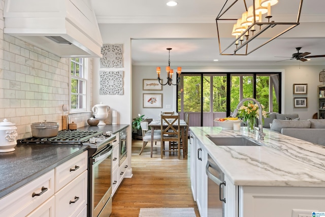 1119 Crest Ave, Homewood, AL 35209 - kitchen featuring a sink, open floor plan, appliances with stainless steel finishes, light wood-style floors, and custom range hood