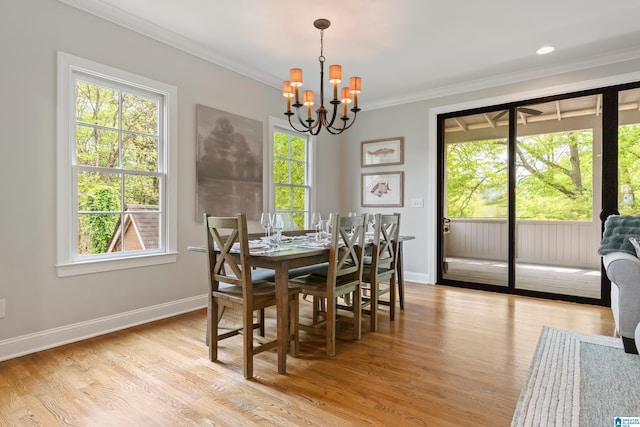 1119 Crest Ave, Homewood, AL 35209 - dining space featuring a chandelier, crown molding, baseboards, and a wealth of natural light