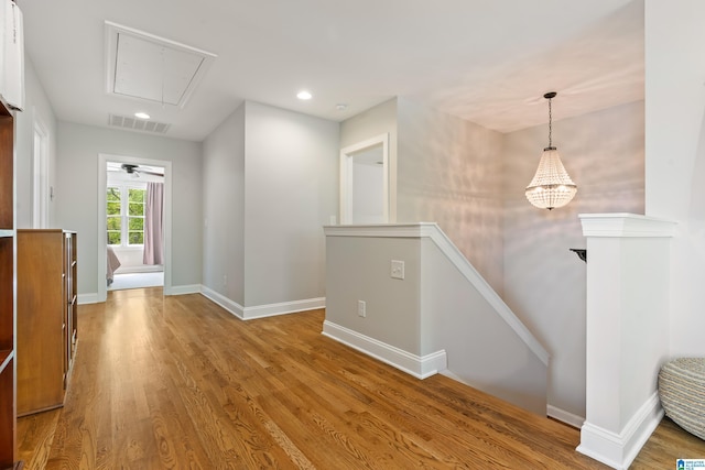 1119 Crest Ave, Homewood, AL 35209 - interior space featuring visible vents, baseboards, an upstairs landing, attic access, and wood finished floors