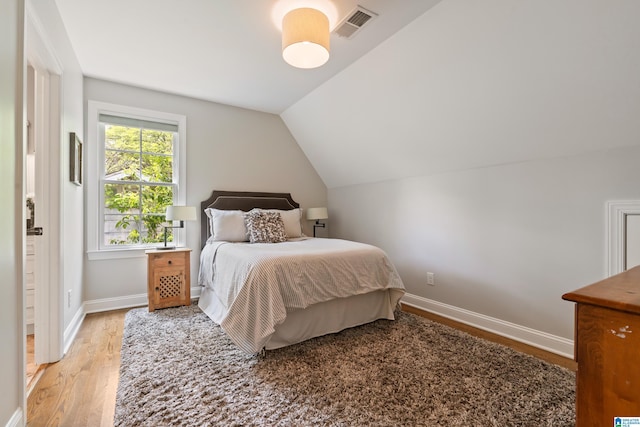 1119 Crest Ave, Homewood, AL 35209 - bedroom with lofted ceiling, visible vents, baseboards, and wood finished floors