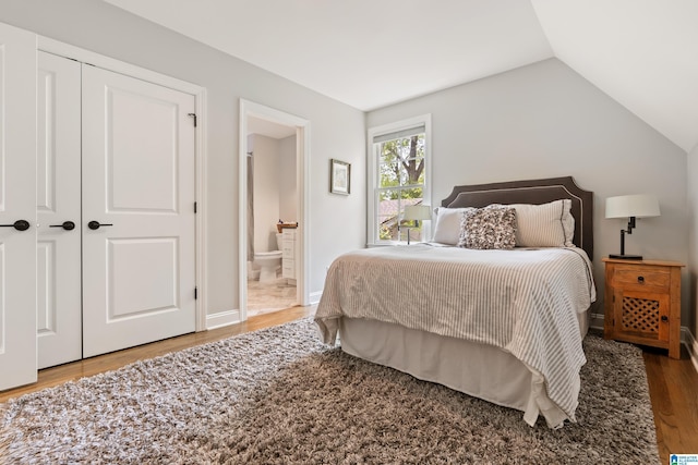 1119 Crest Ave, Homewood, AL 35209 - bedroom with ensuite bathroom, a closet, wood finished floors, and lofted ceiling