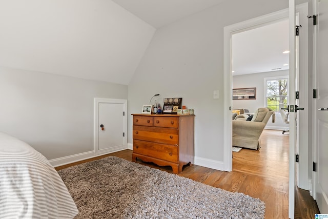 1119 Crest Ave, Homewood, AL 35209 - bedroom featuring lofted ceiling, baseboards, and wood finished floors