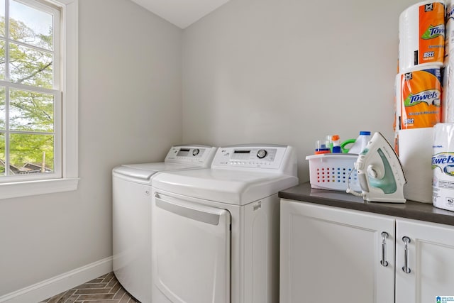 1119 Crest Ave, Homewood, AL 35209 - laundry area featuring baseboards, a wealth of natural light, washer and clothes dryer, cabinet space, and brick floor