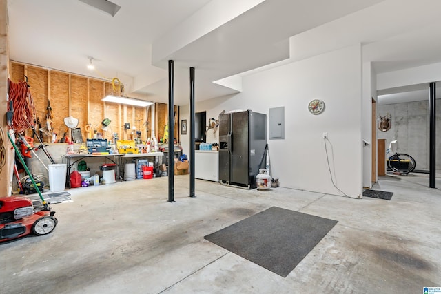 1119 Crest Ave, Homewood, AL 35209 - garage with electric panel, a workshop area, and black fridge with ice dispenser